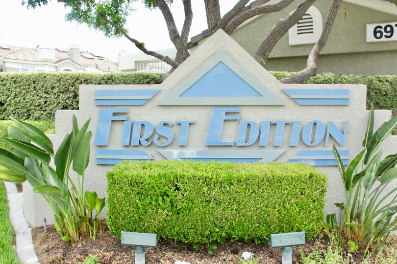 Sign of First Edition with the landscaping garden and trees
