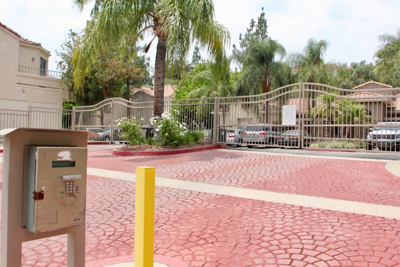 Large parking area with gated entrance and red brick flooring