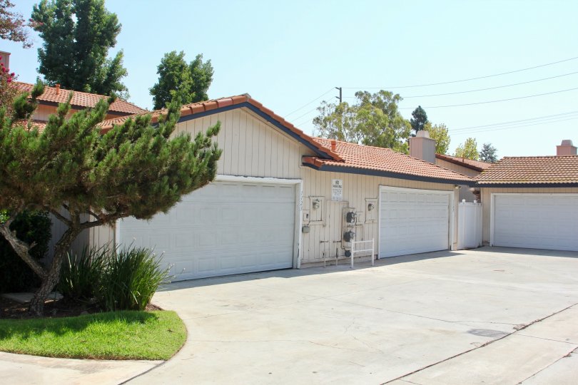 Utility boxes, and meters sit on the front of a garage at the Village Grove Cluster.