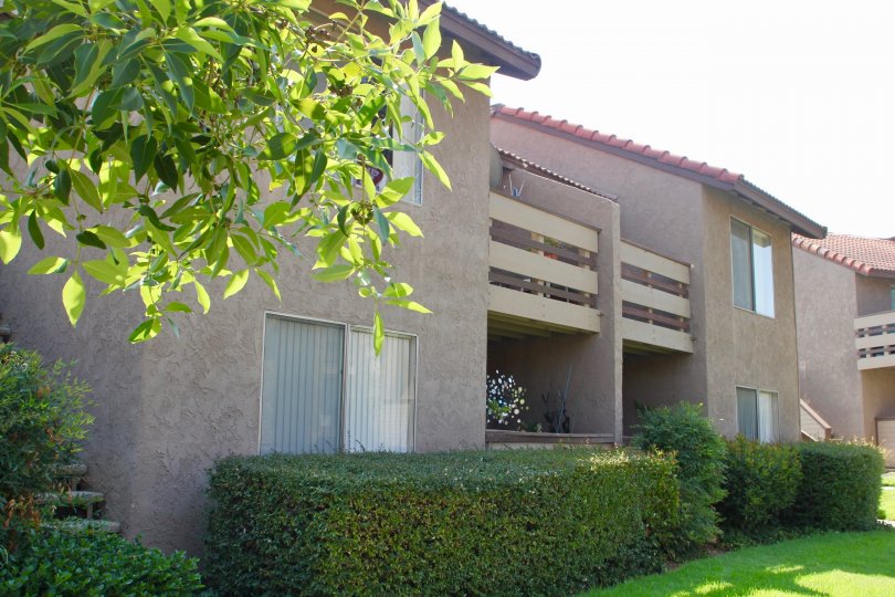 Balcony and patio view of apartments with shrubbery in Windwood community of Corona, CA.