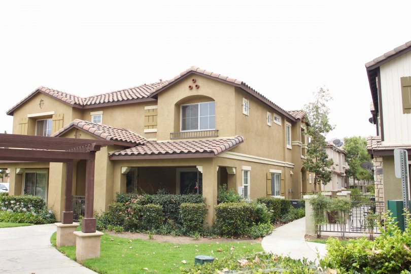 there is beautiful garden surrounded by the house with full of trees and grasses