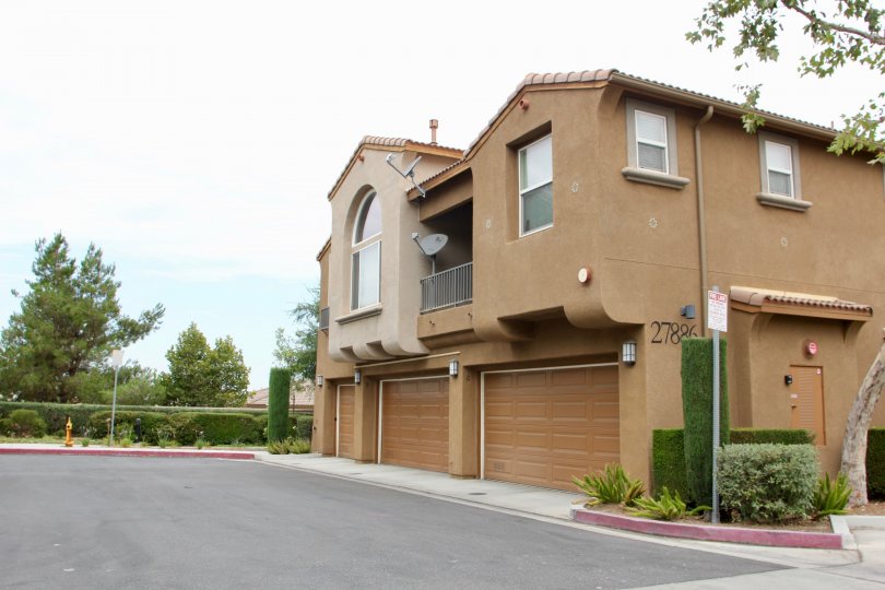 Multiple satellite dishes are festooned on tan townhomes in the Promontory Pointe community