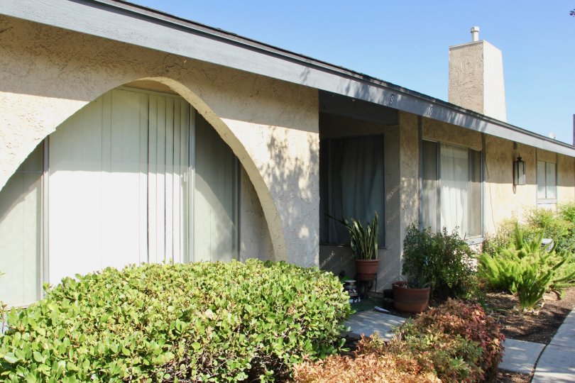 A beige chimney sits on top of a roof of a one story building at Casa De Oro.