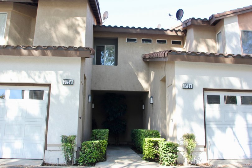 Two adjacent garages, addresses 3758 and 3764 at the Four Seasons Villas in Riverside California