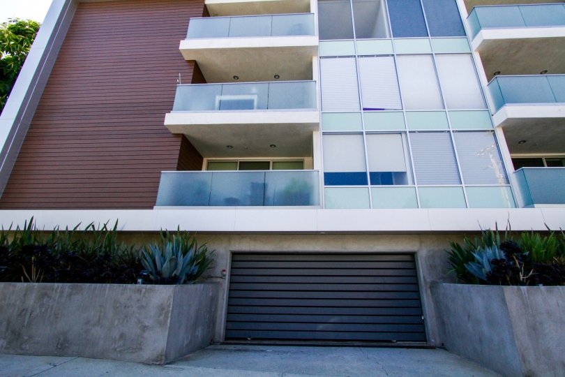 A garage door entrance off the side of the Chenault Flats building