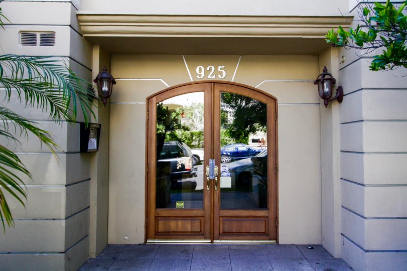 Arched wood doors lead to the lobby of the Westgate Place condos