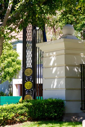 Gold address markers on a metal gate to Le Parc