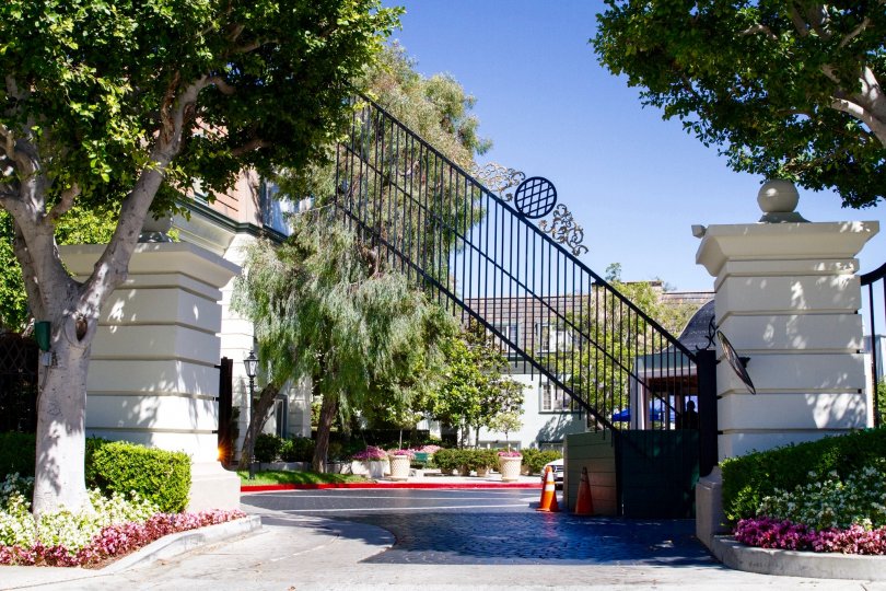 A gate rises to let a car out of the Le Parc community