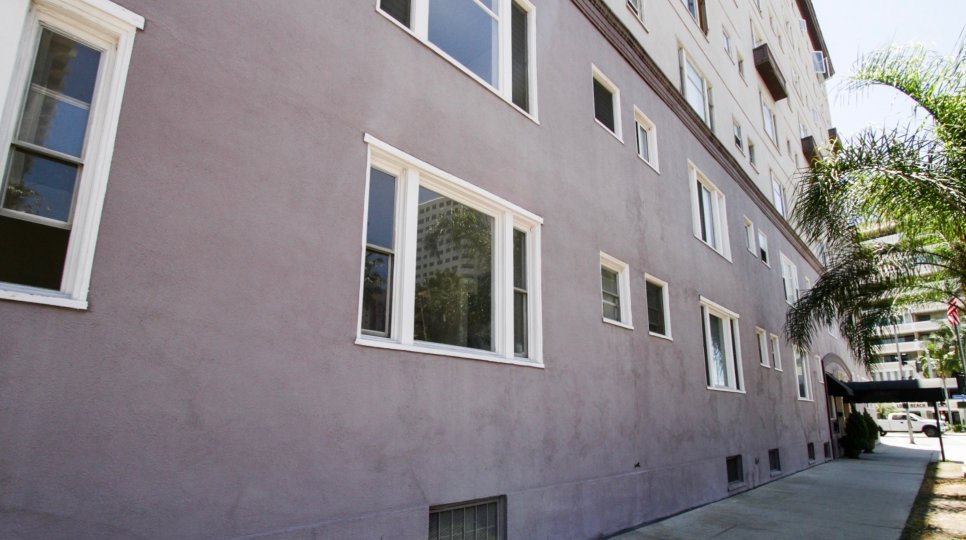 Sidewalk in front of Artaban with a grass planter next to street