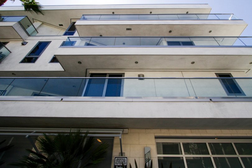 A long balcony with glass railing on second floor of The Oceanside