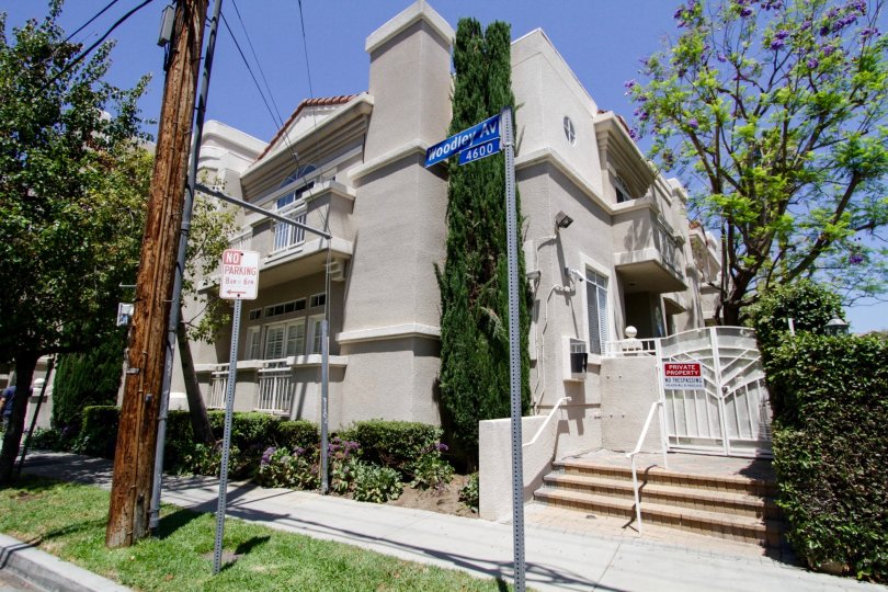 The view of the side entrance to 4630 Woodley Ave complete with landscaping