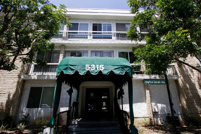 The covered entrance leading into the building at Chateau Encino