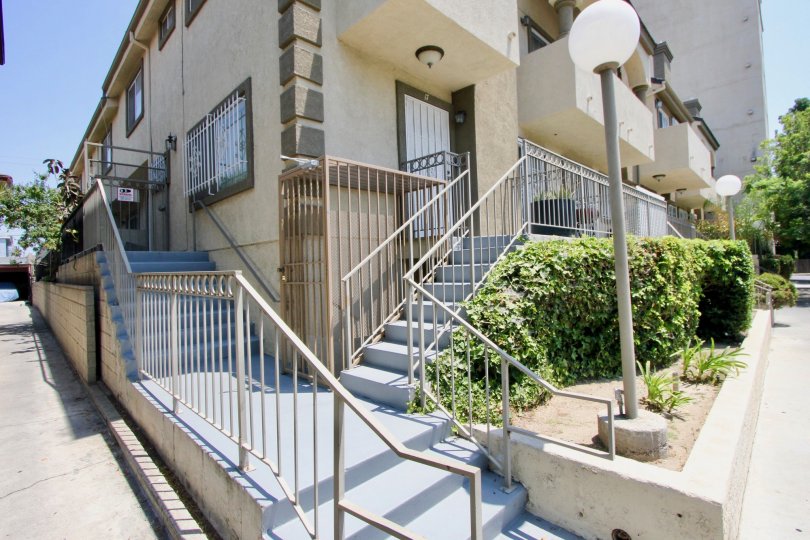 The stairway, lined by shubbery and post lighting, of the Gramercy Place Townhomes in Hancock Park California.