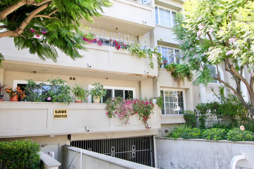 A BUILDING WITH TWO FLOORS AND MORE PLANTS AVAILABLE AT THE FLOOR BALCONY AT THE MORNING TIME