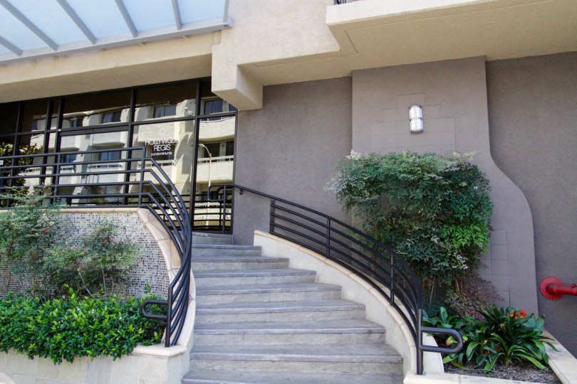 Concrete stairs wrap around to the Hollywood Regis front entrance