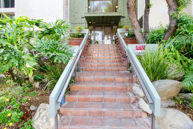 The brick stair of house in the Garden Villas with small bushes and shrubs