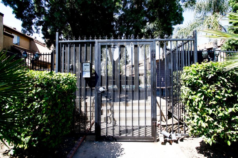 The gated entrance into Woodman Townhomes in Panorama City California