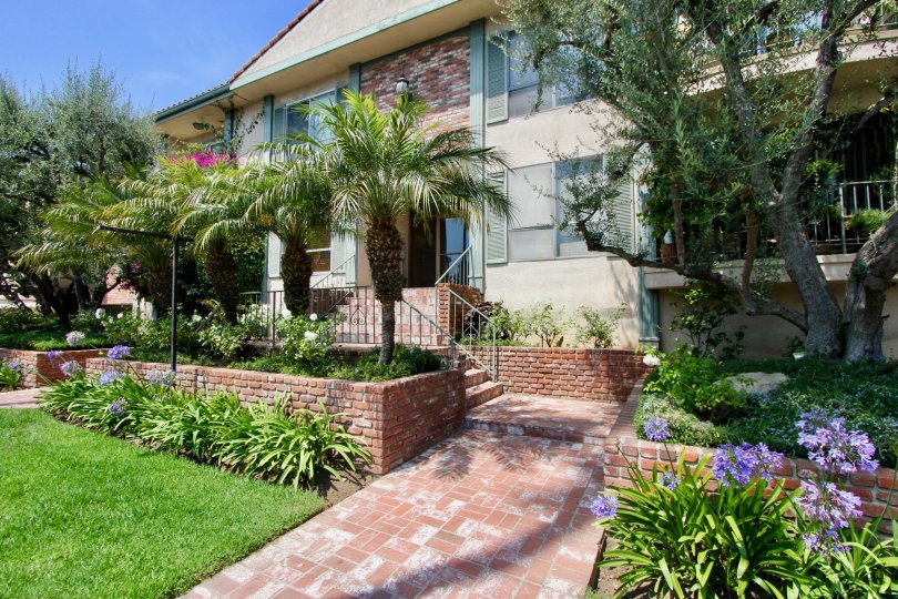 A HOUSE WITH STEPS IN FRONT AND THE ROOF TOP ALSO AVAILABLE SOME PLANTS ALSO IN FRONT OF THE HOUSE