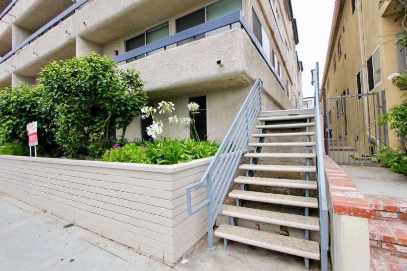 Staircase to 2221 Ocean building with sidewalks on a cloudy day.