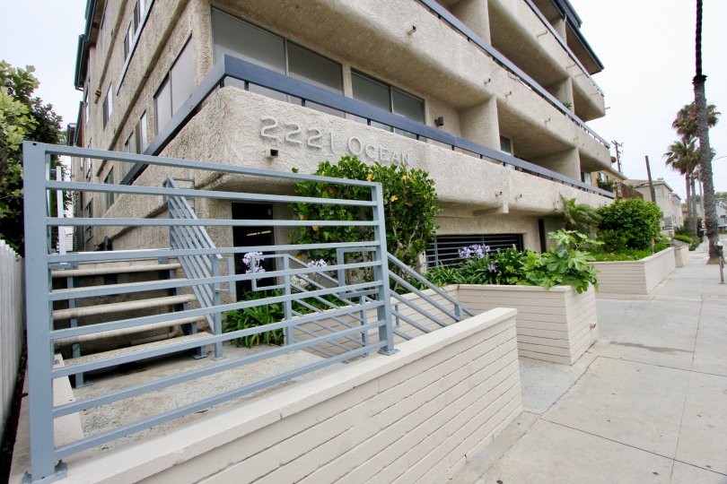 IT LOOKS LIKE A HOTEL WITH THE NUMBER AND ALSO A GATE IN SIDE OF THE BUILDING SOME PLANTS ALSO AVAILABLE THERE