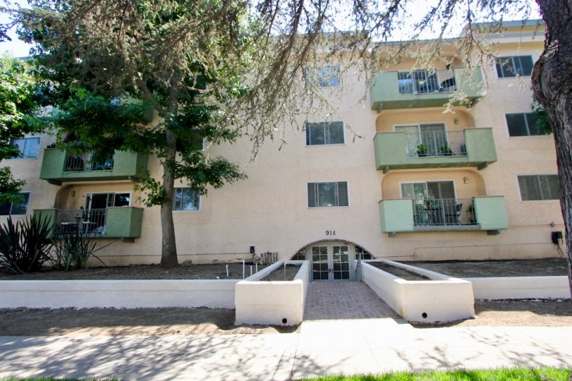 A four-storey housing complex in 914 Lincoln community with green balconies.