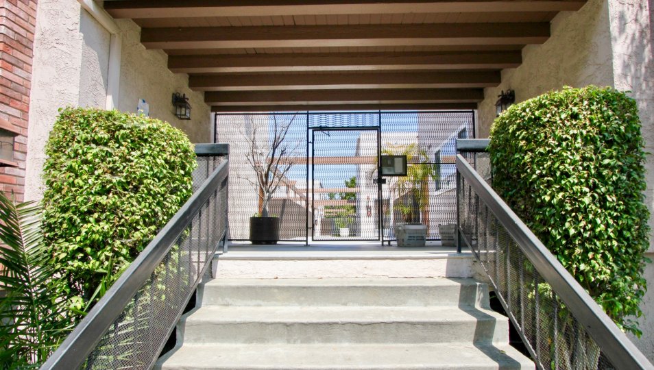 A rustic entrance to the Franklin & Colorado Townhouses with exposed beams as design on the ceiling.