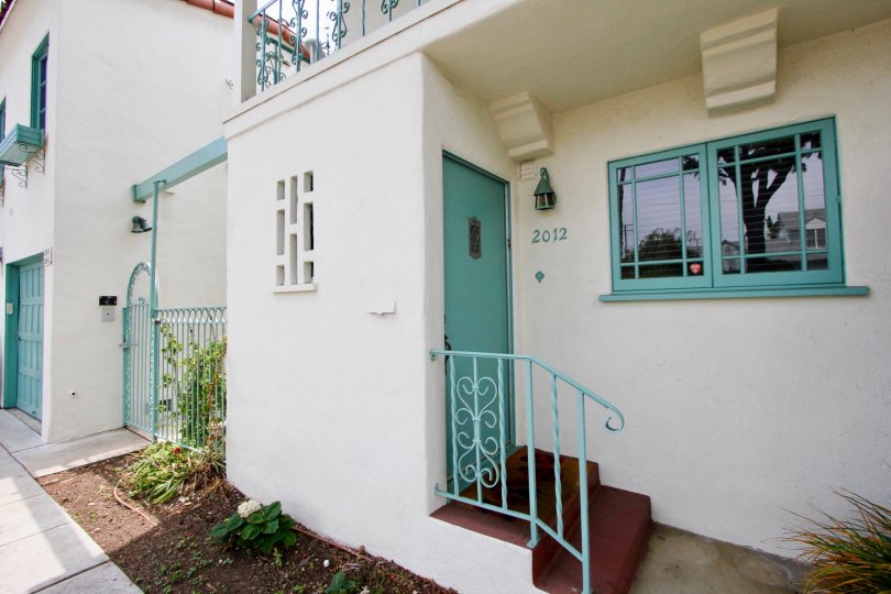 The roof is flat and is covered with red roof tiles. Two large chimneys sit at the side of the house. A few large windows let in just enough light to the rooms below the roof. The house itself is surrounded by a well kept garden. Grass, flower patches and