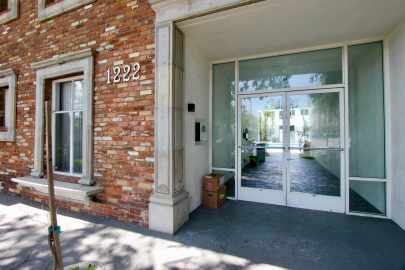 Glass doors leading to a lovely pool in a building with a pleasing brick facade