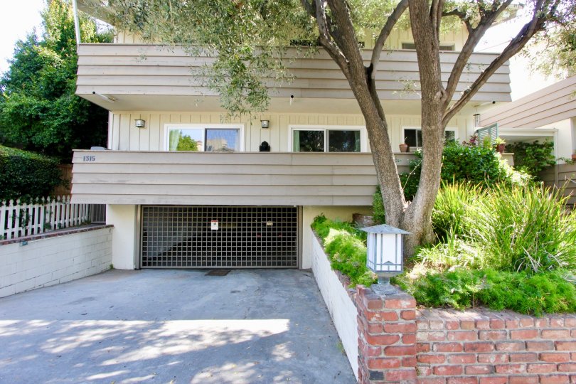 Modern condo at Stanford Street Condos with parking garage, sliding doors, and trees