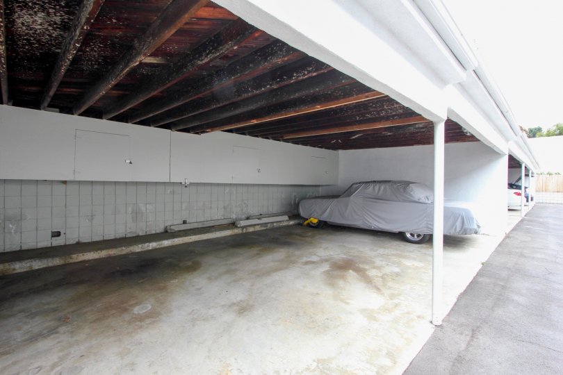 A car in a carport covered by a tarp on Strand IV Santa Monica California