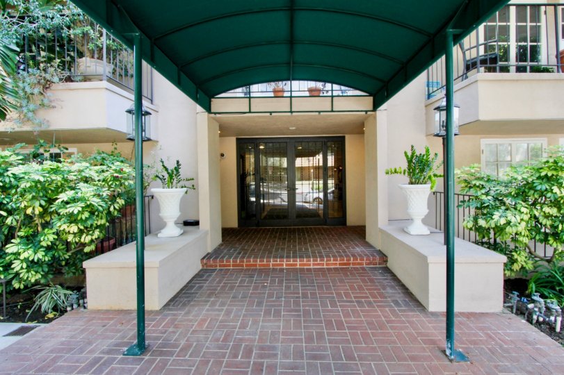 brick styled floor and green roofed walkway of Palm Hancock, West Hollywood, California