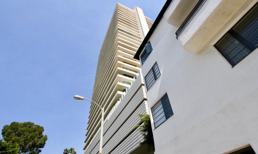 a big white building in sierra towers in a sunny day