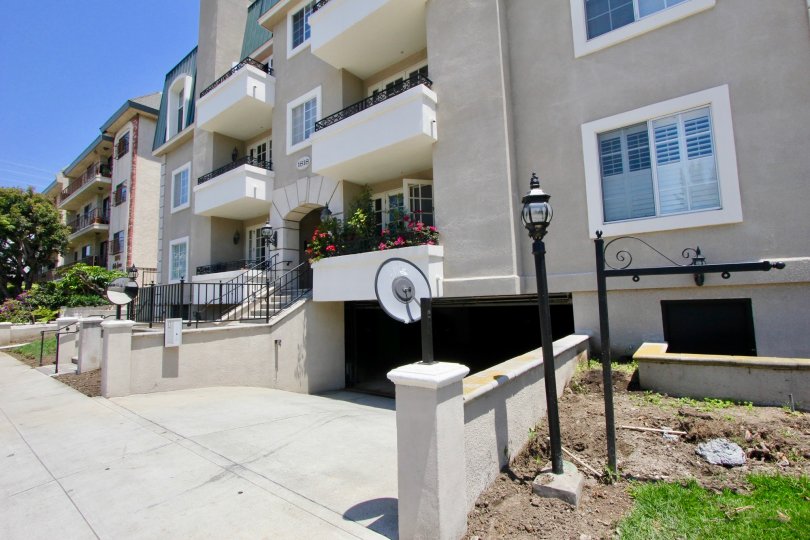 A sunny day in a lovely, well-maintained apartment complex in Colby, West LA with flower boxes and ornate lamps.