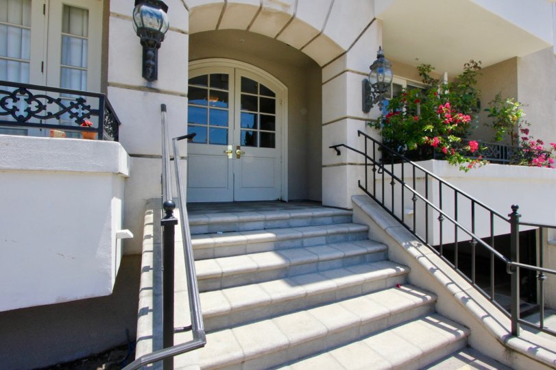 View of front door and steps, balconies and plants at 1818 Colby in sunny West LA, California.