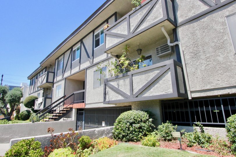 Sunny day at 1914 Corinth in West LA, California. A nice garden, stairway entrance, balconies and windows.