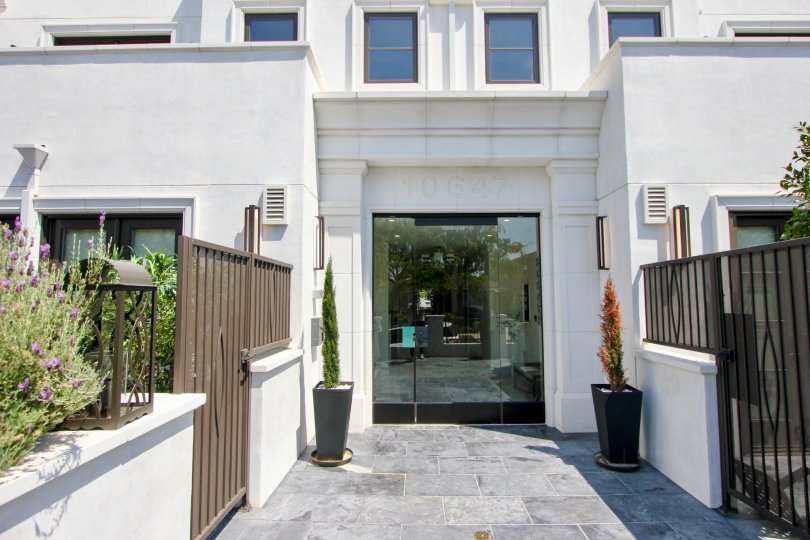 A lovely day at The Ashton Cortina, a white and brown residential building with style and protected gardens.