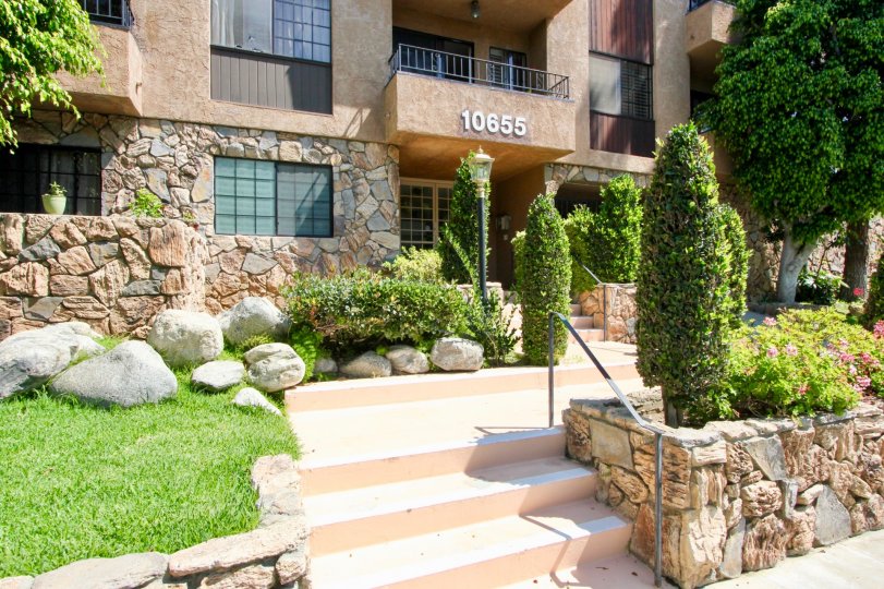 A sunny day with decorative trees and bushes with breezy windows at Kelton Vilas.