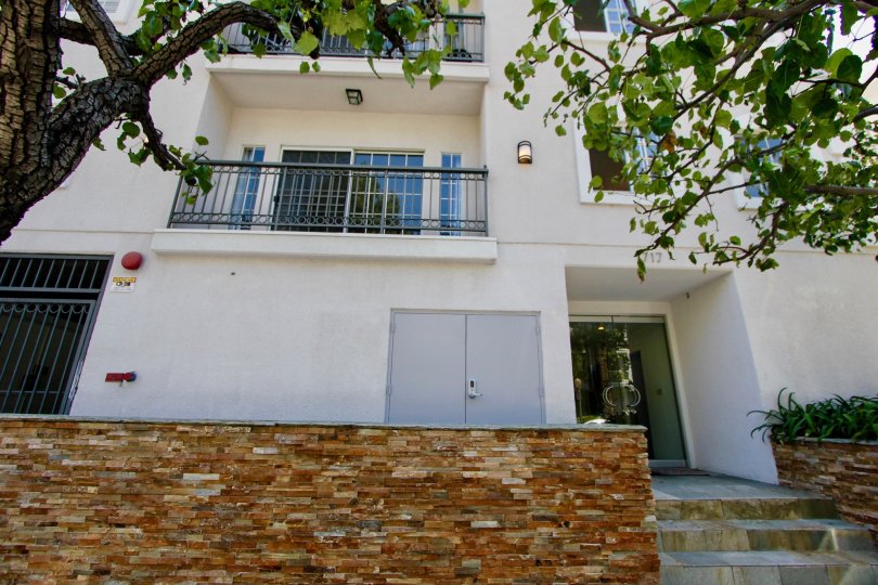 A cool day in the Malcolm Regency with a white color building and steps.