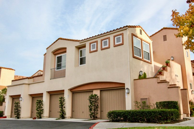 a warm day in the seacove villas with house that has glass windows on 2 and 1 storey