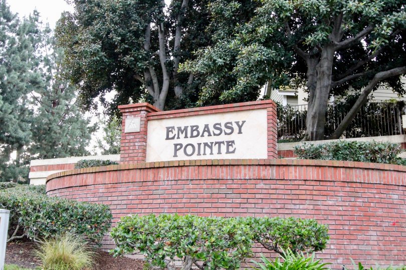 THE HOUSE IN THE EMBASSY POINTE WITH THE EMBASSY POINTE WALL, PLANTS, TREES