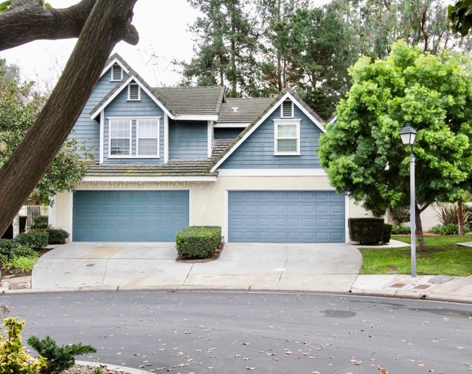 THE HOUSE IN THE EMBASSY POINTE WITH THE SHUTTERS, PLANTS, TREES, LAWN