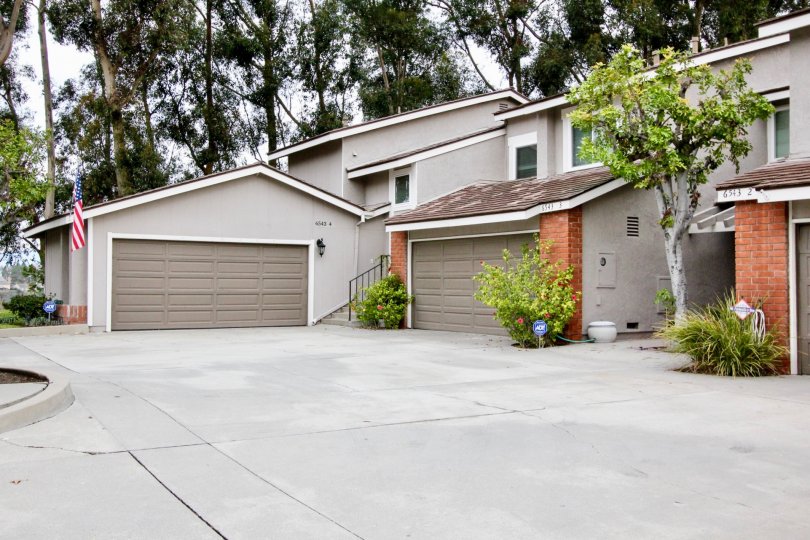 clean and clear area view in front garage near house having trees and plants around in Parkview Townhomes