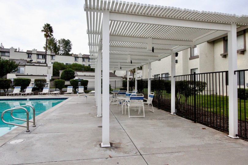 THE FLAT IN THE RANCHO YORBA WITH THE SWIMMING POOL, CHAIRS, LAWN
