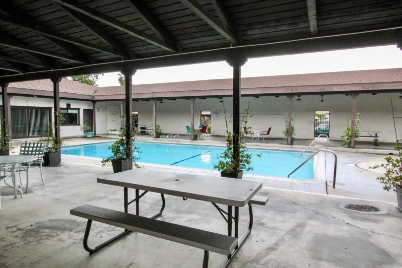 A pool area inside Casa Emperador community surrounded by a porch