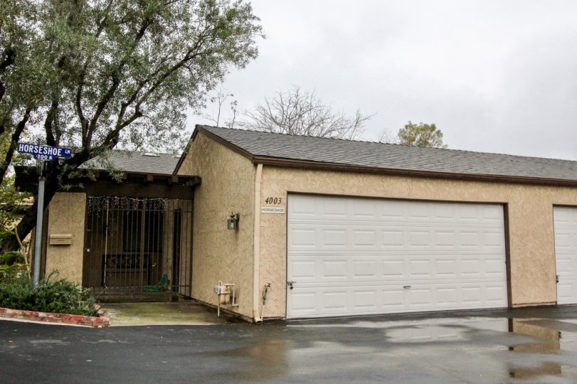 A home and garage viewed from the front yard on a cloudy day in the Gateway Americana community