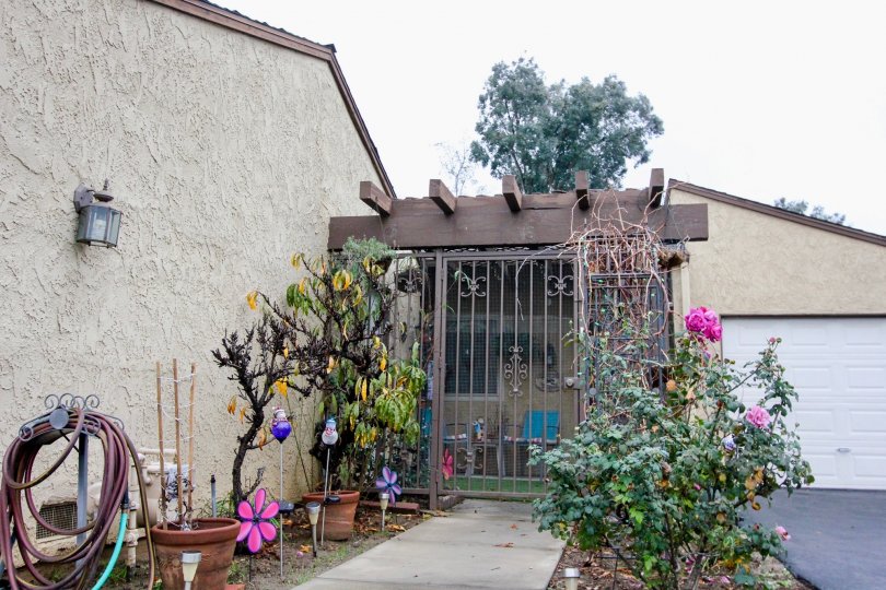 THIS IS THE ENTRANCE TO THE HOME WHICH SHOWS THE SOME PLANTS WITH FLOWERS IN THE ANAHEIM CITY