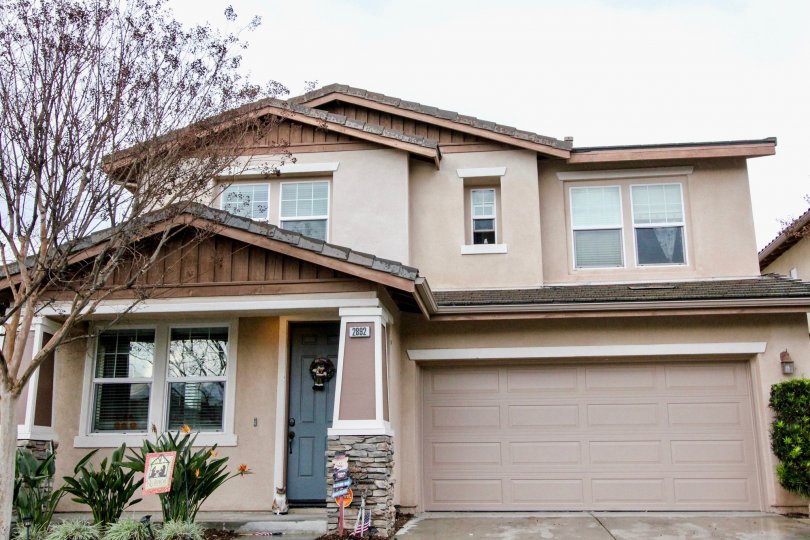 A large brown garage door inside of a home with a tree at Rio vista Walk in Anaheim CA