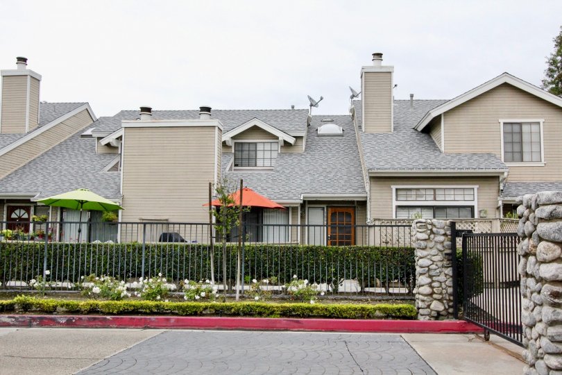 THIS IMAGE SHOWS THE HOUSE ON THE FRONT PLANTS, UMBRELLA, EMPTY SPACE, DISHES ARE THERE IN ANAHEIM CITY