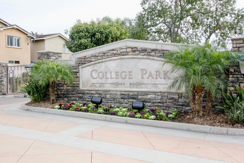 THIS IMAGE SHOWS THE ENTRANCE WAY WITH NAME BOARD LOCATED IN BUENA PARK ON THE FRONT PLANTS ARE THERE