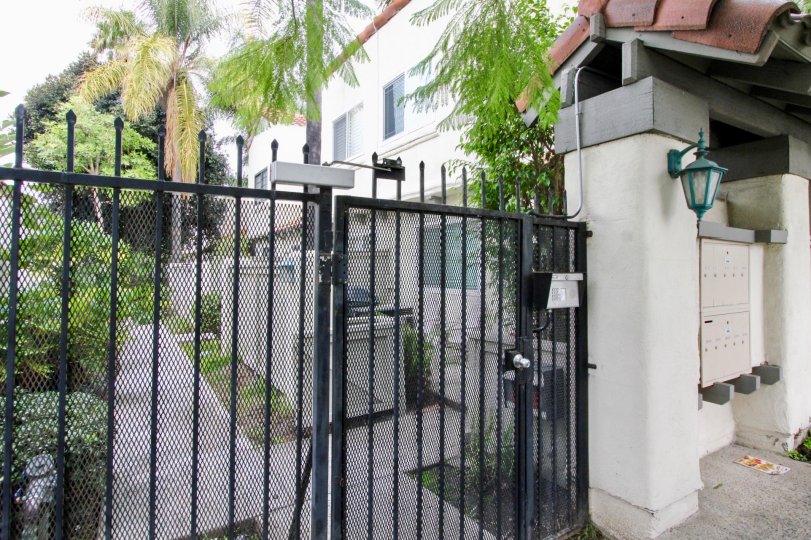 A black color gate in the Palm Vilas with a light.